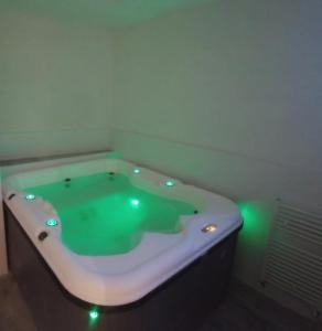 a bath tub with green lights in a bathroom at Puerta de Alcaraz in Alcaraz +25 photos