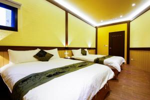 Postel nebo postele na pokoji v ubytování Qing Xin Ju Homestay