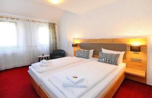 Postel nebo postele na pokoji v ubytování Vico's Hotel & Restaurant Asperg
