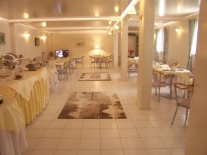 a dining room with tables and chairs with white tables at Sailor's Nautical Concept in Spetses