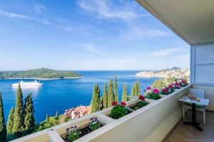 a balcony with a view of the ocean at Deluxe Sunset Room, view of the Old Town in Dubrovnik