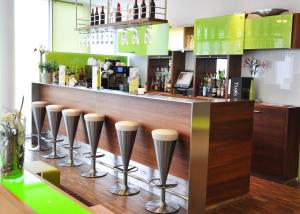 a row of stools at a bar in a restaurant at SportHotel Kaiserau in Kamen