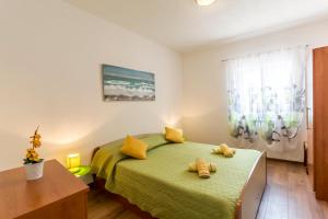 Ein Bett oder Betten in einem Zimmer der Unterkunft Apartments Petra