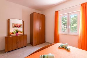 Ein Bett oder Betten in einem Zimmer der Unterkunft Apartments Petra