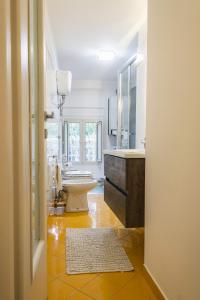 a bathroom with a toilet and a sink and a mirror at Sirenide in Sorrento