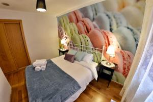 a bedroom with a bed with two pillows on it at WonderStays Apartamentos La Estación in Málaga