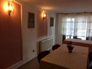 a dining room with two tables and a window at Pension Casa Alba in Slănic-Moldova +29 photos