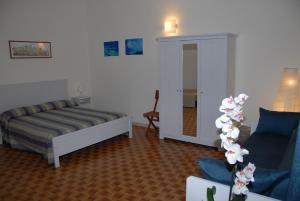 a bedroom with a bed and a couch and a chair at I due mari in Gaeta
