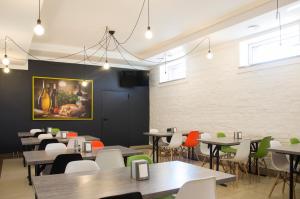 a restaurant with tables and chairs and a painting on the wall at euroHOTEL Sosnowiec Kazimierz in Sosnowiec