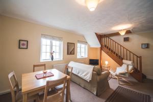 a living room with a couch and a table at Llwyngwair Manor, Newport, PEMBROKESHIRE in Newport
