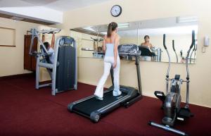 a woman standing on a treadmill in a gym at Boutique Hotel Palacio in Santo Domingo