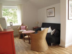 a living room with a couch and a table at Landhaus Dr. Seiffert in Scharbeutz