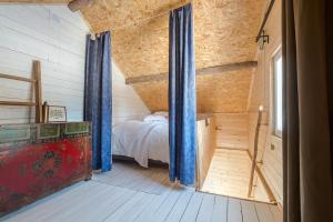 a bedroom with a bed in a wooden house at Stuga Petruslogen in Malung