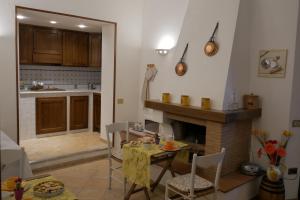a kitchen and living room with a table and a fireplace at Antica Bottega di Vinci in Vinci