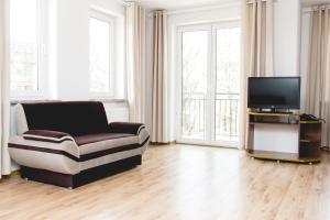 Televízia a/alebo spoločenská miestnosť v ubytovaní Apartment Olymp