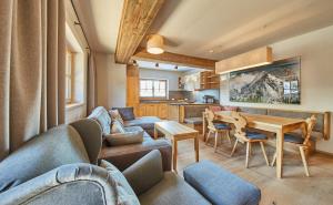 a living room with a couch and a table at Chalet Guter Hirte in Saalbach Hinterglemm
