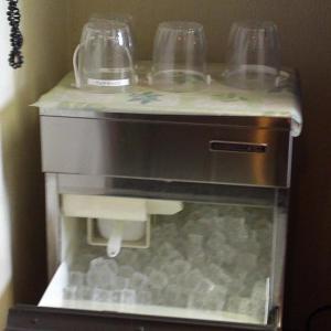 a coffee machine with two glasses on top of it at Smile Hotel Koriyama in Koriyama