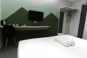 Postel nebo postele na pokoji v ubytování Hotel 99 Kota Kemuning