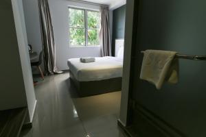 Postel nebo postele na pokoji v ubytování Hotel 99 Kota Kemuning