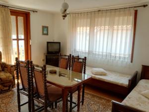 a living room with a dining room table and a couch at Apartment Marchela in Nesebar