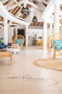 a room with chairs and a rug on the floor at Coin de Mire Attitude in Cap Malheureux