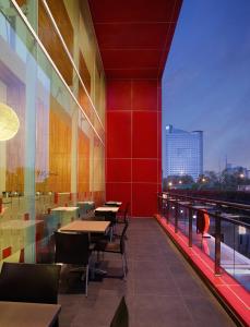 a restaurant with tables and a view of the city at Amaris Hotel Tendean in Jakarta