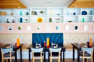 a dining room with two tables and chairs at St Moritz Hotel and Cowshed Spa in Polzeath