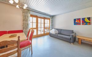 a living room with a table and a couch at Appartement Bernkogel in Saalbach Hinterglemm