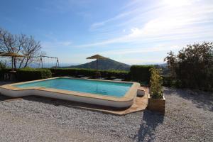 a swimming pool in the middle of a yard at Holiday House ¨Montepiscina¨ in Cómpeta
