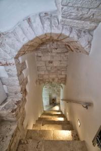 a staircase in a castle with a stone ceiling at Dimora Lumi in Locorotondo
