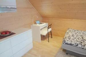 a room with a bed and a desk with a laptop at Fully equipped flat, 2 bedrooms, FREE car parking. in Trondheim