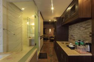 a bathroom with a shower and a sink and a tub at Hotel Marshyangdi in Kathmandu