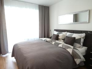 a bed in a bedroom with a large window at Good Vienna Apartment in Vienna