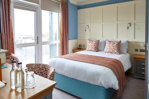 a hotel room with a bed and a window at Trearddur Bay Hotel in Trearddur