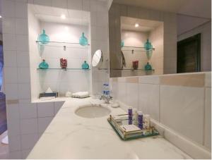 
a bathroom with a sink, mirror and bath tub at Dar es Salaam Serena Hotel in Dar es Salaam
