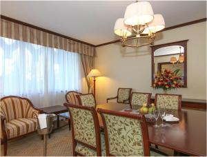 a dining room with a table and chairs and a room at Dar es Salaam Serena Hotel in Dar es Salaam