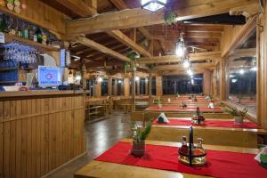 a restaurant with a row of tables and a bar at Sinia Vir Eco Residence in Medven