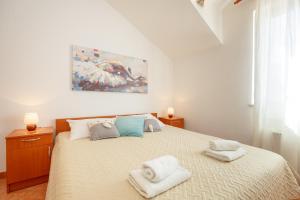 Postel nebo postele na pokoji v ubytování Apartments Mondo