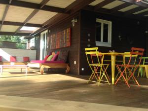 a patio with chairs and a table and a couch at belle la vie in La Plaine des Cafres