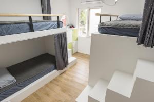 a room with two bunk beds and a window at Hannahstay Women Only Guesthouse in Jeju