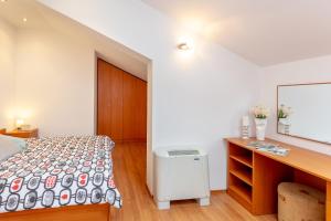 Postel nebo postele na pokoji v ubytování Apartments Mondo