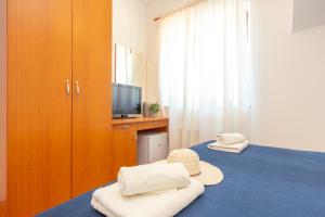 Postel nebo postele na pokoji v ubytování Apartments Mondo