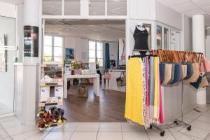 a clothing store with a rack of clothes at Thalacap Île de Ré - Thalasso & Spa in Ars-en-Ré