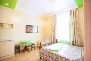um quarto com uma cama, uma cadeira e uma janela em Mini-Apartments on Sverdlova em Ecaterimburgo