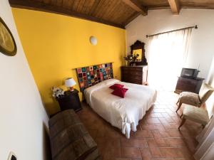 a bedroom with a bed and a yellow wall at Casa Di Mamma Casa Vacanze in Genga