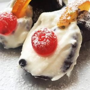a piece of cake with a fruit on a plate at B&B D'Amico87 in Bagheria