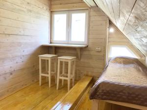 a bedroom with two stools in a tiny house at Stare Selo in Kolochava