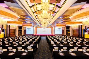 a large room with rows of tables and chairs at Nanjing Central Hotel in Nanjing