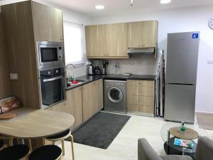 a kitchen with stainless steel appliances and a table at Luxury Studio Ayia Napa Center in Ayia Napa