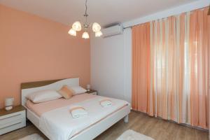 a bedroom with a bed and a large window at Apartment Ani in Slano
